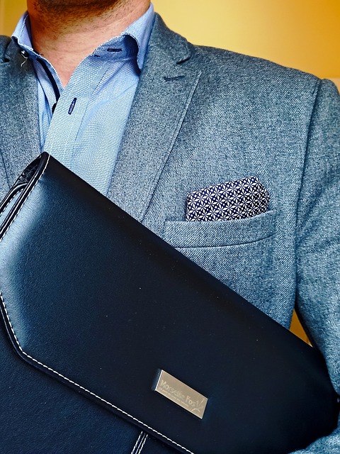Employer in suit with files pouch